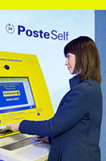 Woman getting stamps at the italian post office machine