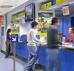 people standing at the counter of an italian post office