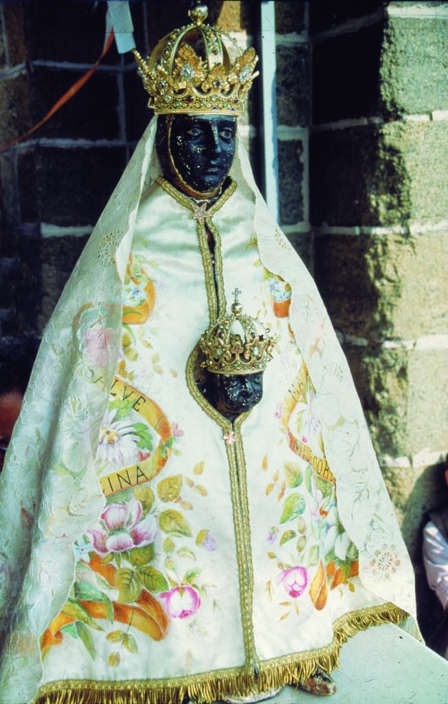Black Virgin Mary in France in Puy en Velay with baby Jesus wearing a crown and clothed in an ornate flower dress