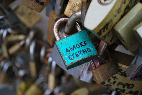 padlocks of love on a bridge with one lock saying "Amore Eterno"