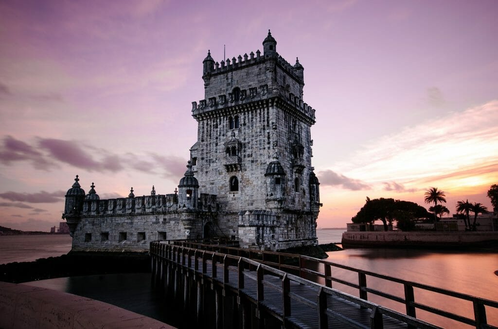 tower of Belem in Lisbon at sunset with stunning purple sky in the background