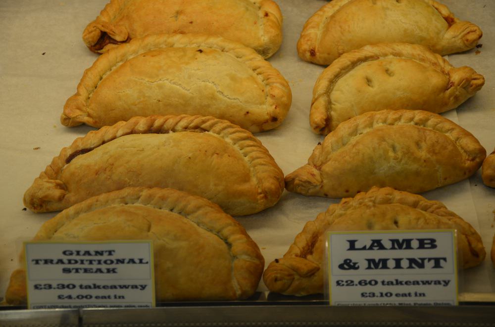 English pasties are giant half-folded crescents of thick, buttery pastry folded around hot, steaming fillings.