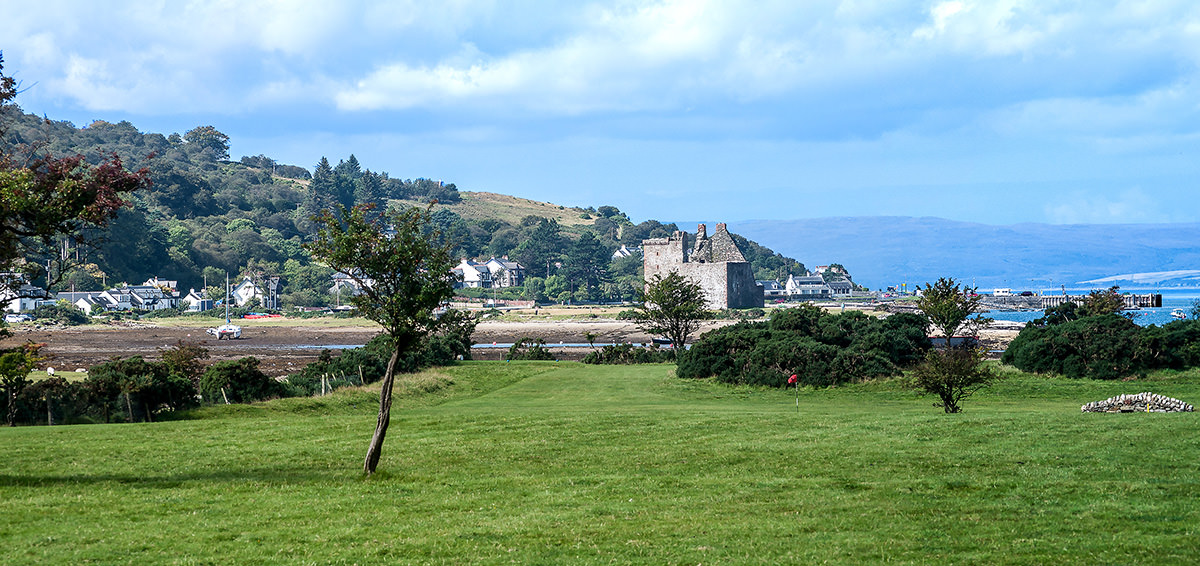 The town and castle of Lochranza in the northwest of Arran. Kintyre is across the Sound of Kilbrannan in the blue distance.