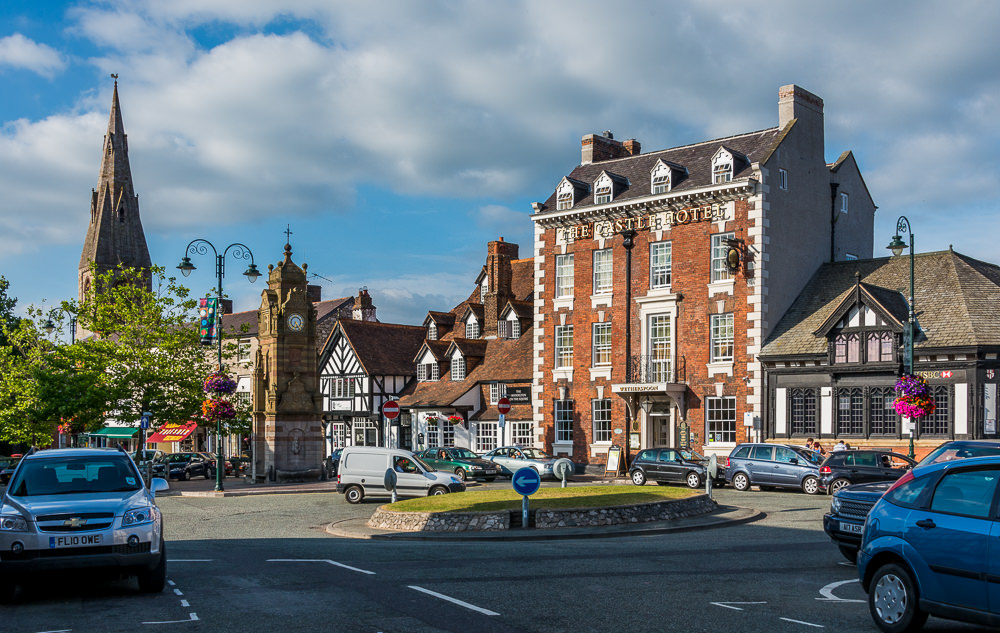 The red brick façade of the Myddelton Arms pub and Castle Hotel on one side and St. Peter’s Church nearby make an entrancing place for people watching