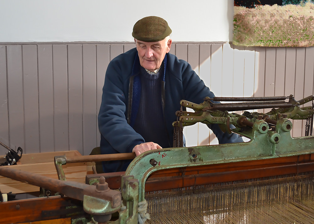 The pedal loom demonstrates the weaving process. It clicks and clacks as the weaver pedals and takes about thirteen hours to finish a complete bolt. Courtesy: Harris Tweed and Knitwear