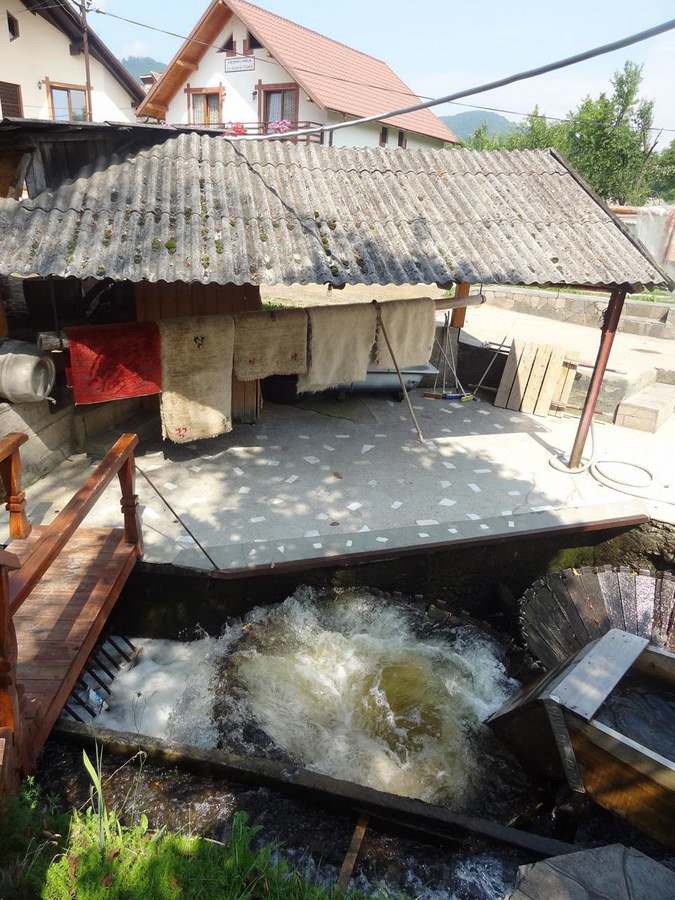 old style way of washing rugs at La Moara la Niculai in Vadu Izei, Maramureș country