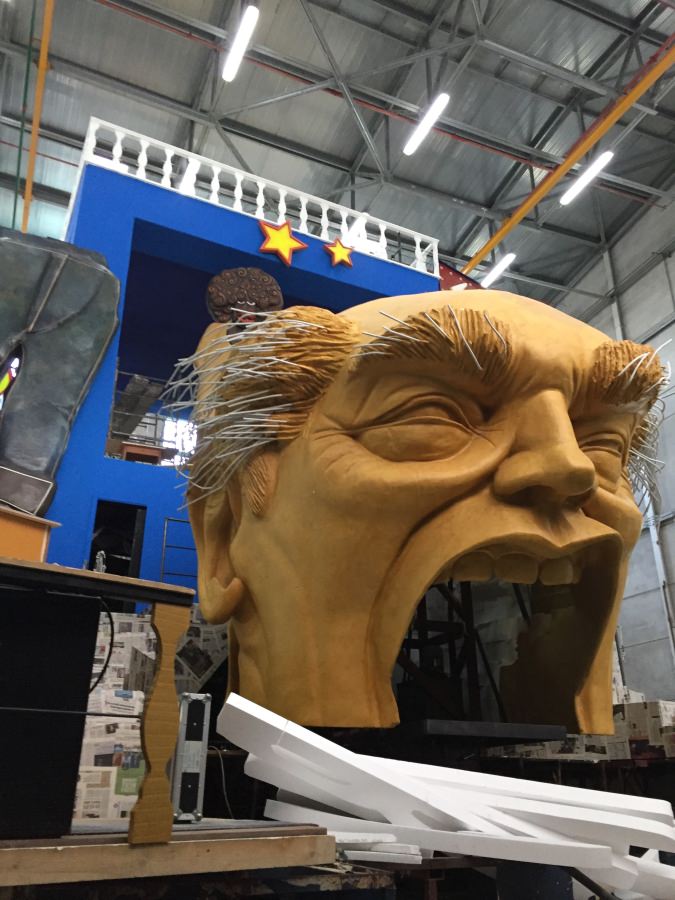 carnival float featuring head of donald trump under contruction