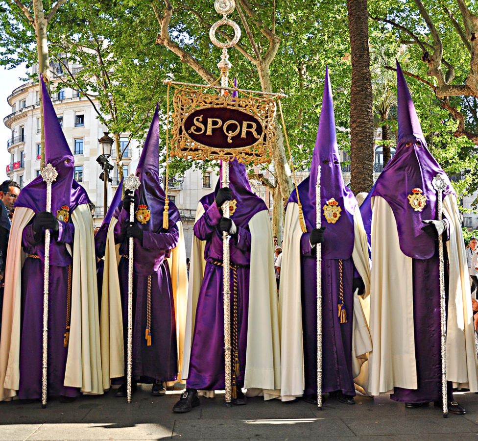 People dressed in purple and white hooded dresses for Easter in Spain