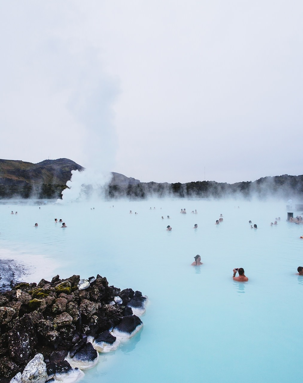 people bathing in light blue steaming water at the Blue Lagoon Iceland - Photos of Iceland