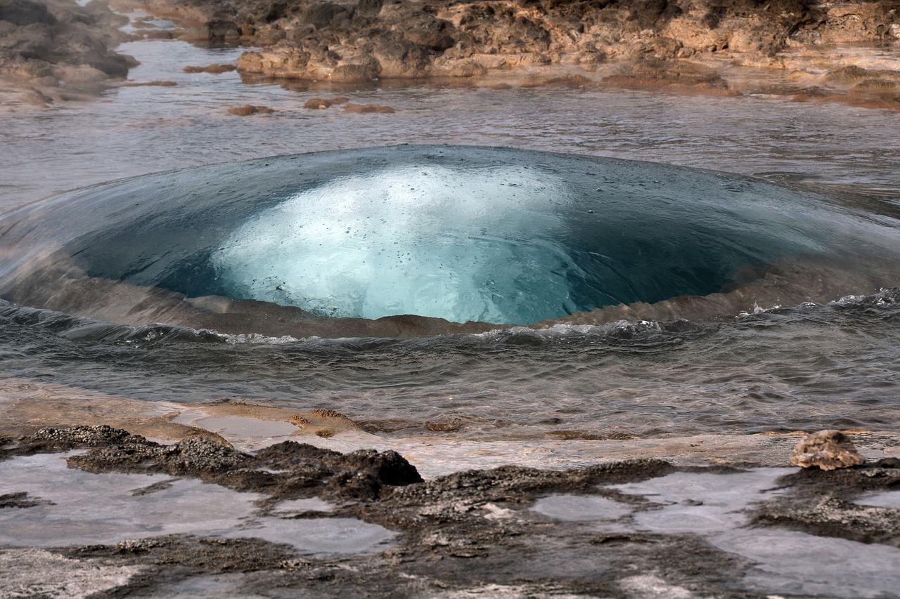 Bubbling geyser hole with hot water