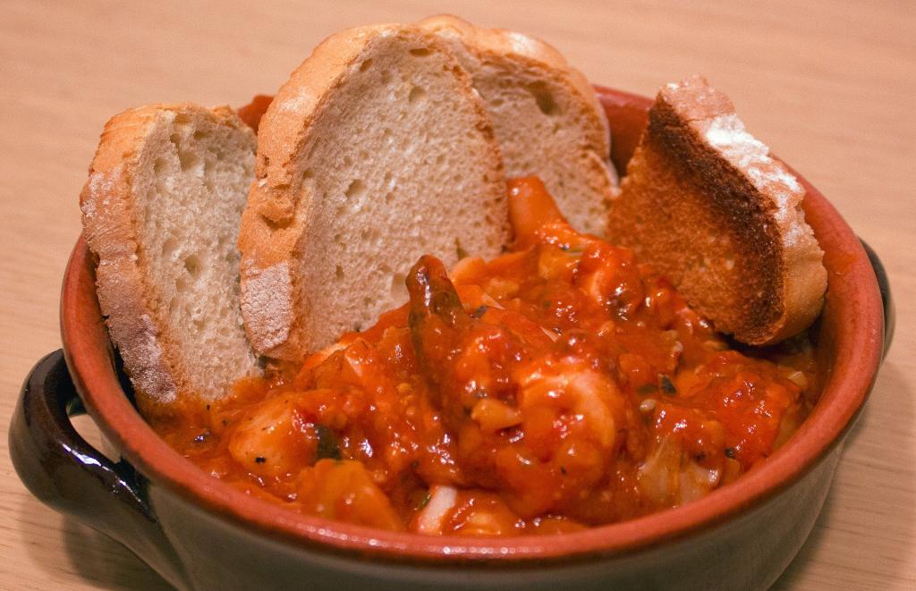 Tuscan food in Livorno- Cacciucco tomatoe-y fish soup with bread