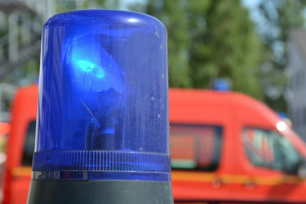 Blue light of an emergency vehicle with red emergency vehicle in the back