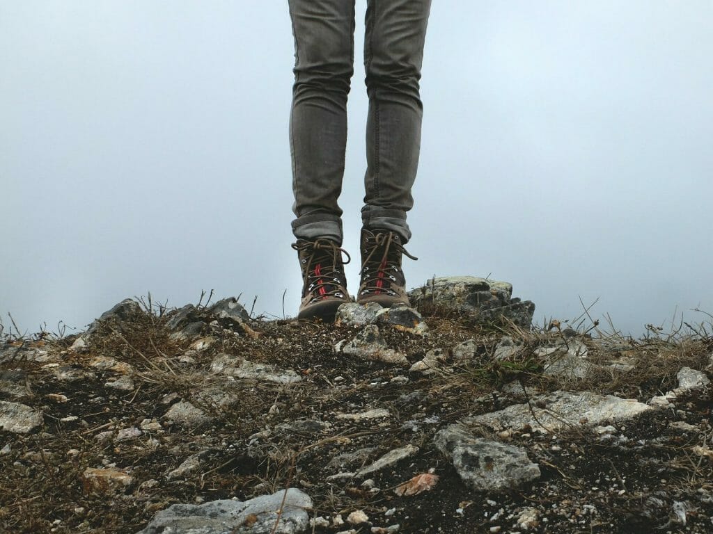 lower legs with hiking boost standing on rocks
