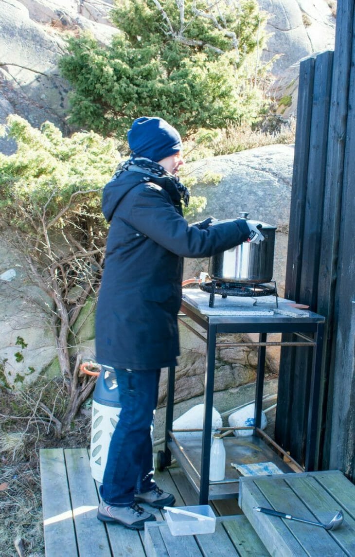Woman cooking outside in Sweden