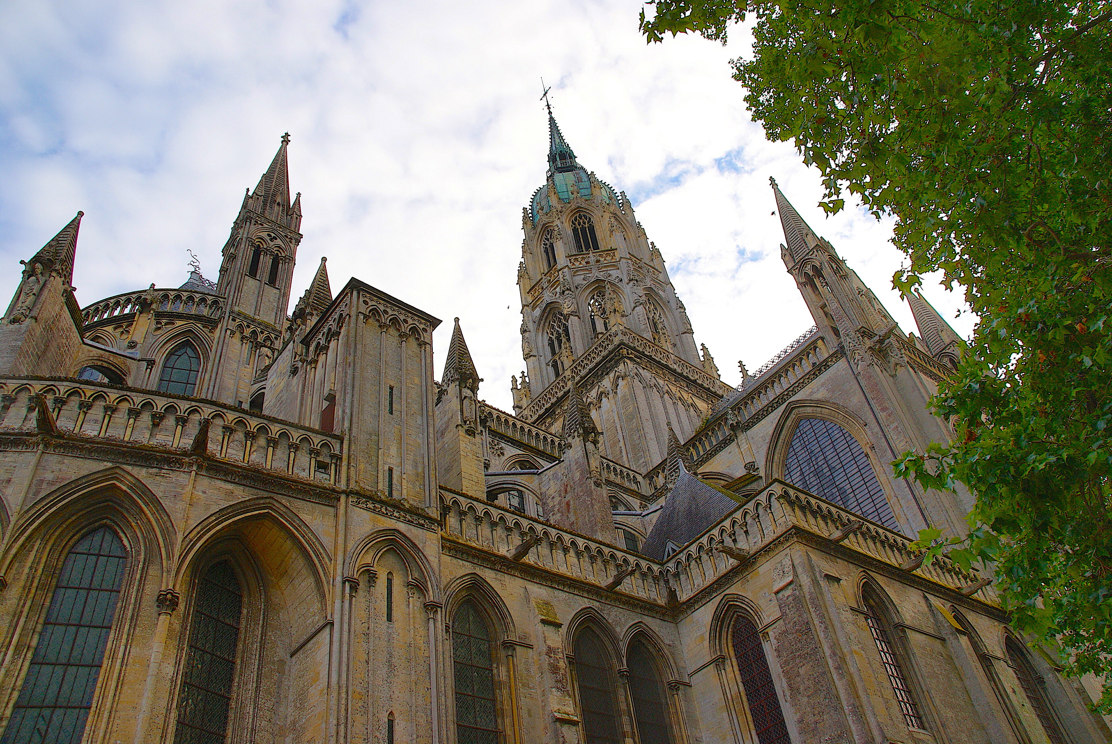 Looking up at the Gothic windows and spires of Bayeux Cathedral