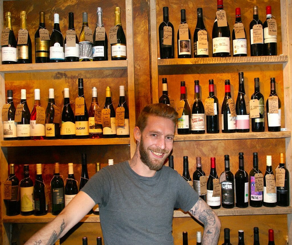 Man in front of lots of wine