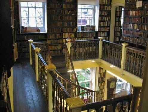 The top floor of the Bromley House Library with a peak down into the main floor