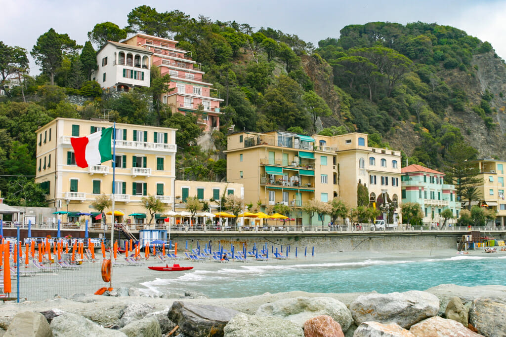 Cinque Terre Hike - Beach chairs and umbrellas at Monterosso Al Mare beach. The photographer (that would be me) is standing on the breakwater in the Ligurian Sea.