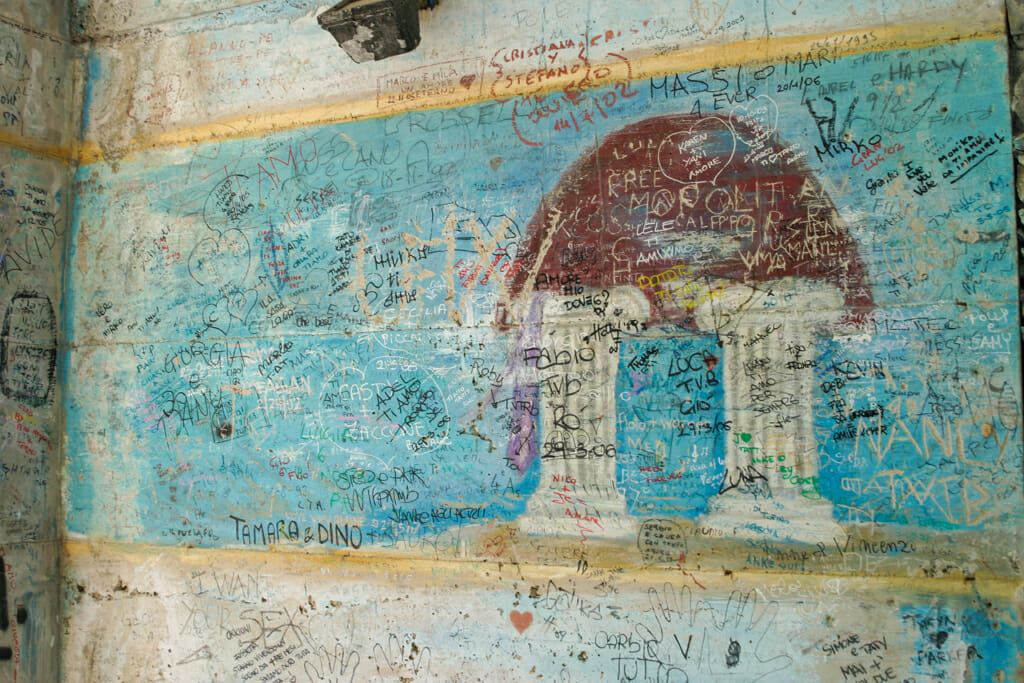 Famous and historical graffiti on Via dell’Amore coastal trail near Riomaggiore.