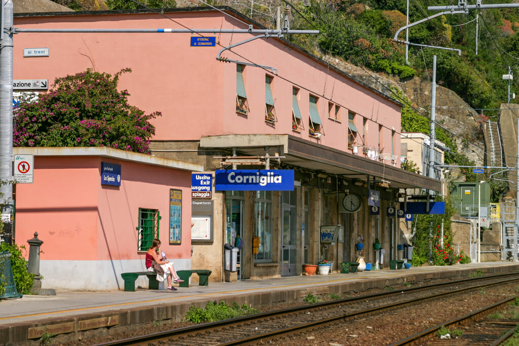 Pink building in front of Train tracks - Corniglia train station in the Cinque Terre.