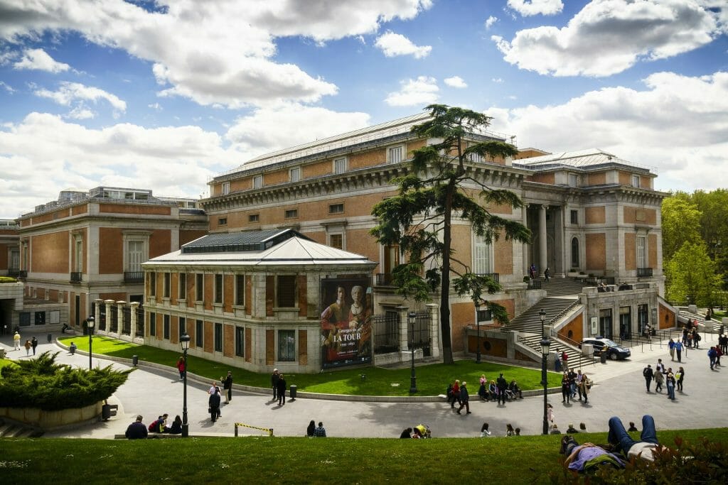 Short distance view of the Prado Museum with pedestrians and visitors walking around