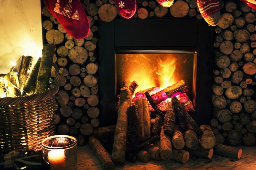 Blazing fireplace with stockings hanging over it 