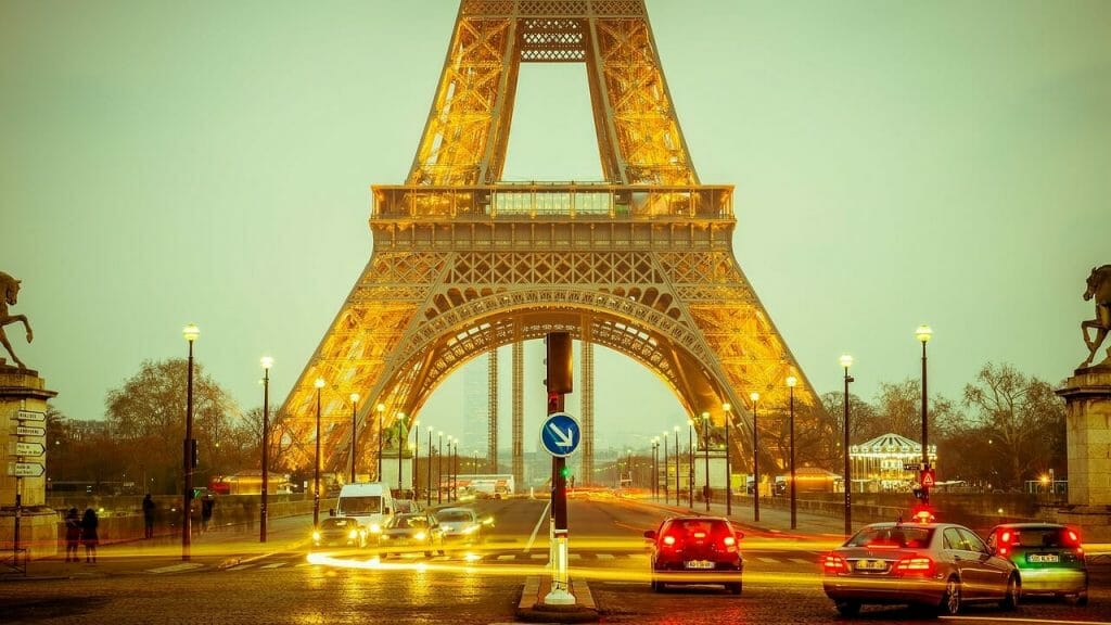 The Eiffel Tower with cars speeding around it
