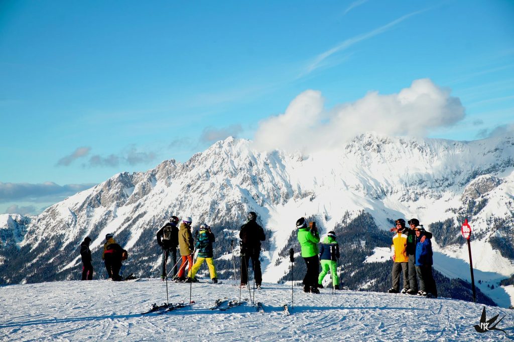 Skiers reveling at the picturesque mountains