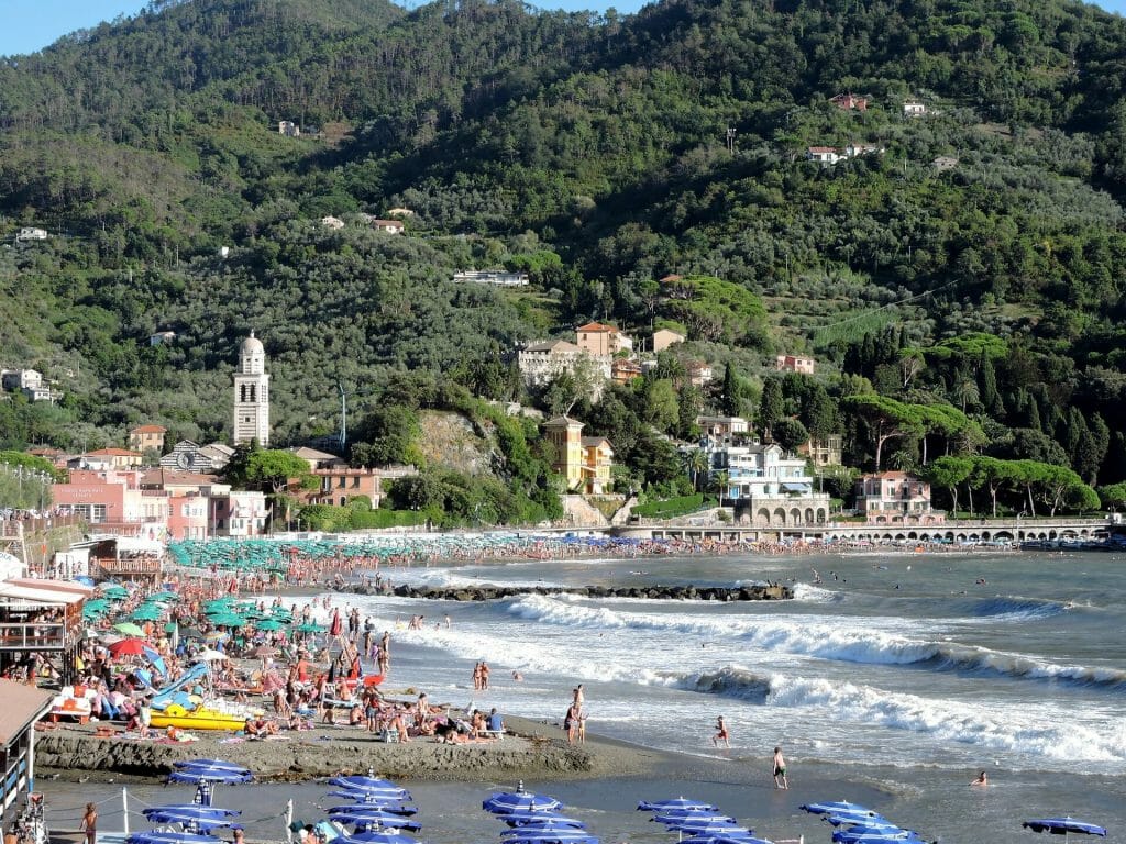 A plethora of people having a beach day on the sandy shore of Levanto