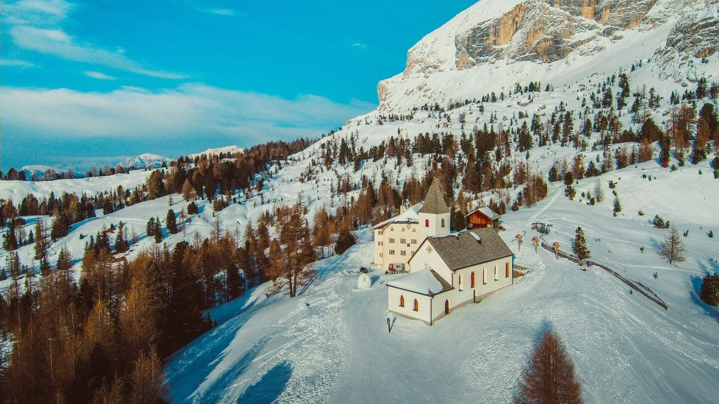 Church in the middle of the Alta Badia mountain area with the sun shining