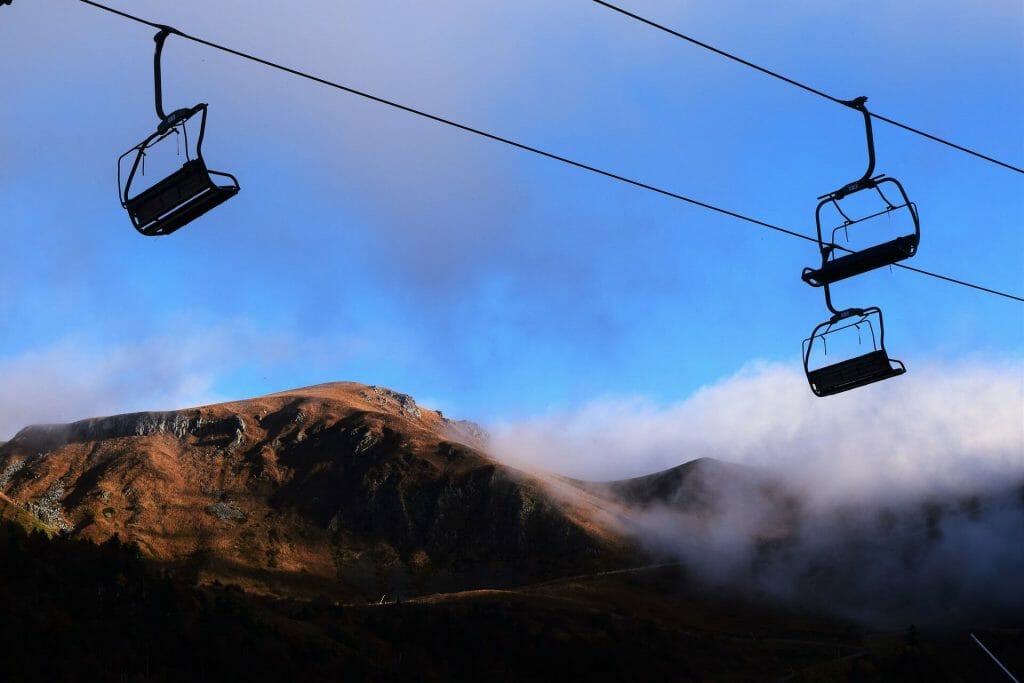 Chair lifts going over the slope in the sunny off season