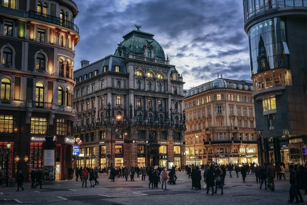 Calmly lit Vienna town with people humming around to get places