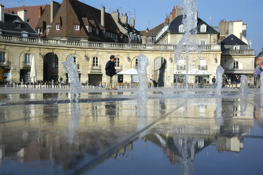 Place de la Libération fountain with reflection in the water