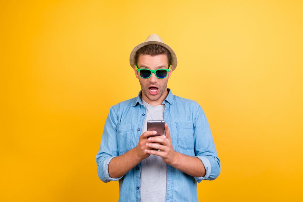 Man with Phone in front of Yellow background