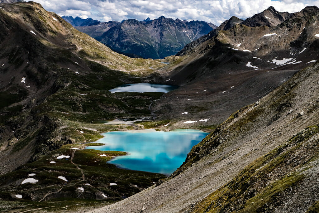 Grey Mountain landscape with bright blue lakes at the bottom of the valley