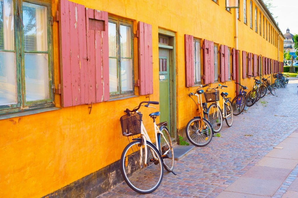 Bicycles leaning on old yellow building in Copenhagen