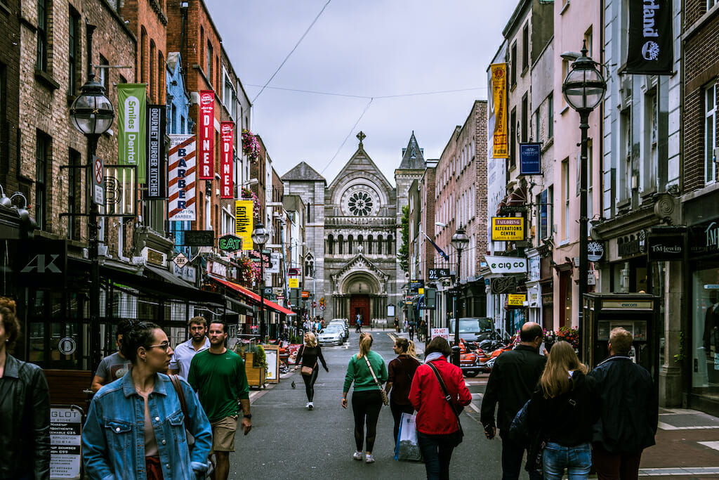 People walking down the cobblestone streets in Dublin
