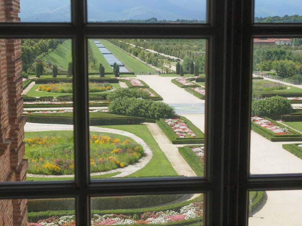 Gardens of the Reggia di Venaria Reale photographed through a window from the palace