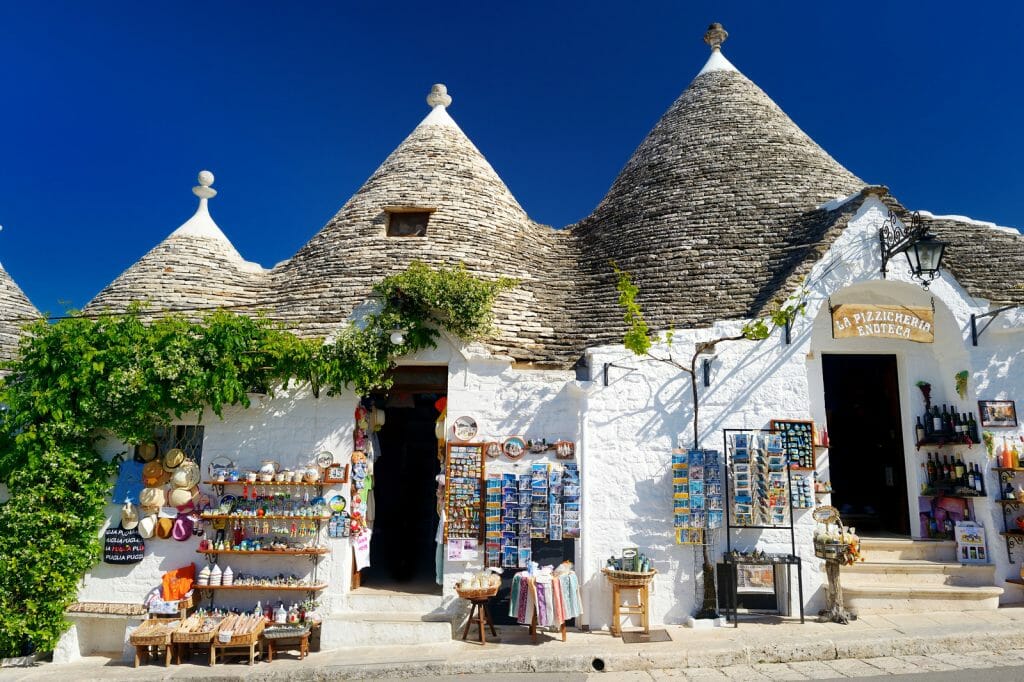 ALBEROBELLO, ITALY - Traditional trulli houses whitewashed round houses with coneshaped grey roofs