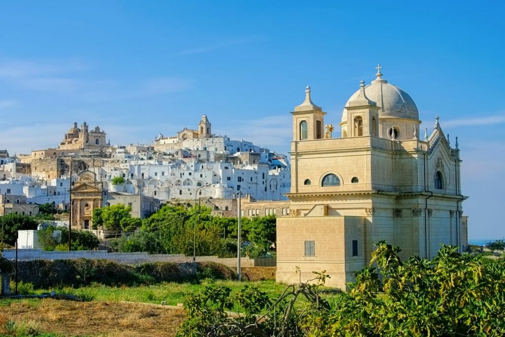 Ostuni Puglia - A Large domed church in the foreground and the city of Ostuni in the background, also known as the white citythe old town Ostuni in Apulia, Italy