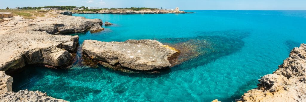 Picturesque seascape with white rocky cliffs, caves, sea bay and islets at Grotta della poesia, Roca Vecchia, Salento Adriatic sea coast, Puglia, Italy