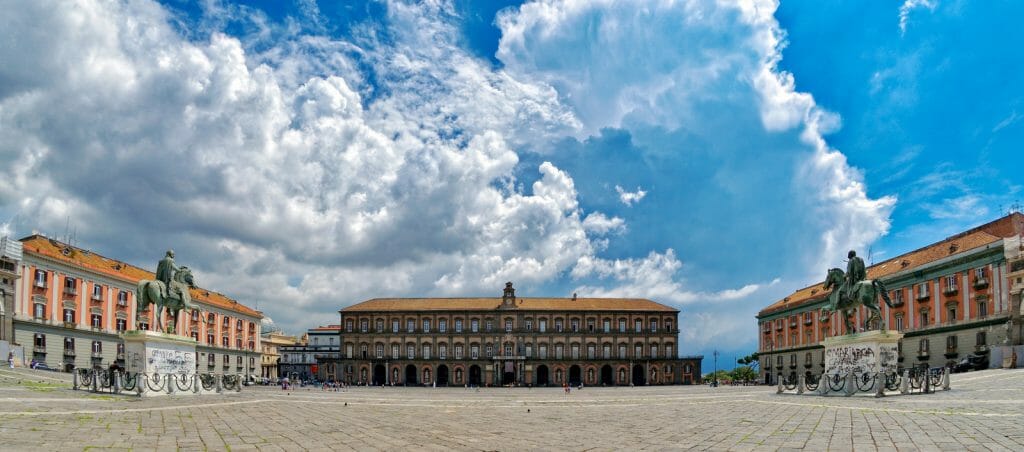 Large Piazza in Naples with blue sky and dramatic clouds