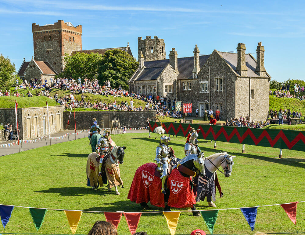 Jousting Tournament at Dover Castle with participants dressed as knights on horses jousting in front of Dover Castle