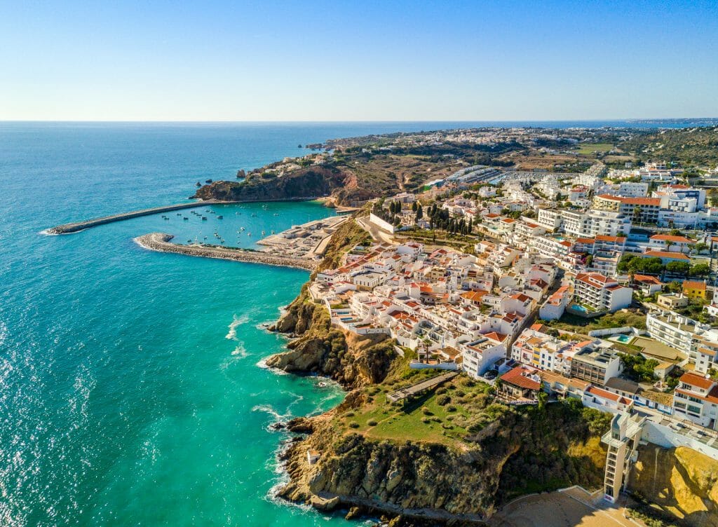 Aerial view of marina and white architecture above cliffs in Albufeira, Algarve, Portugal