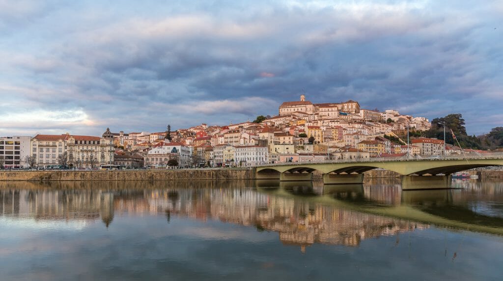 Coimbra cityscape reflecting in the water of the 