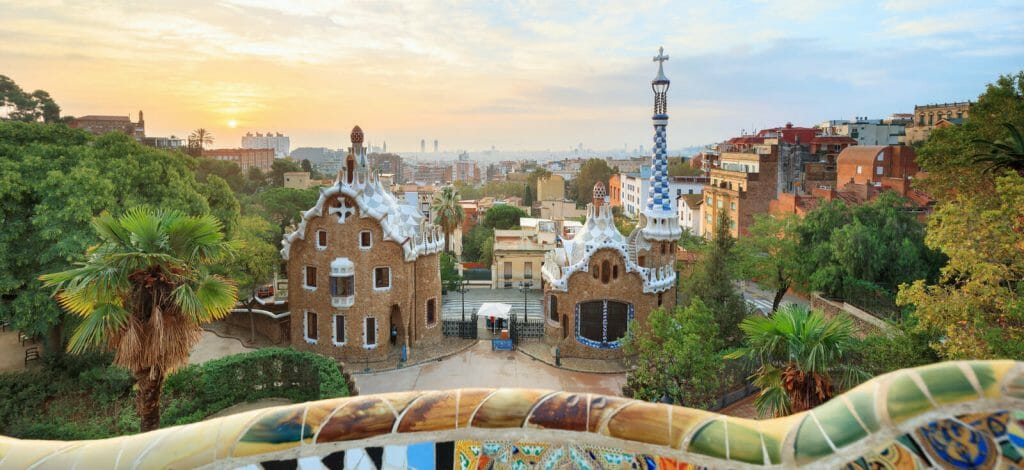 Park Guell in Barcelona. View to entrace houses with greenery on foreground