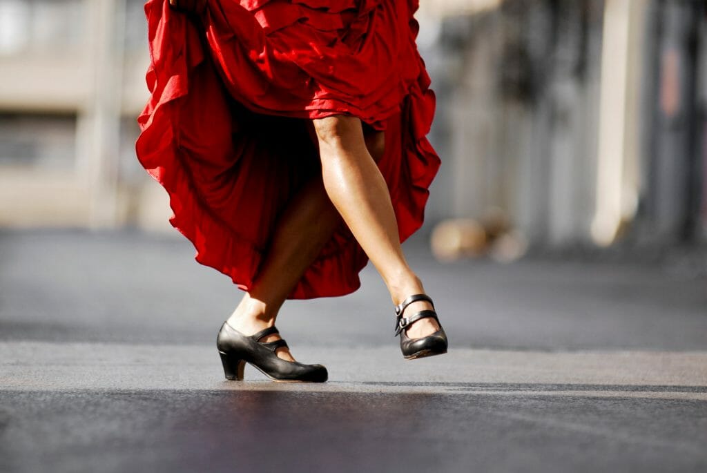 Closeup of Female flamenco dancer's feet and legs and red dress