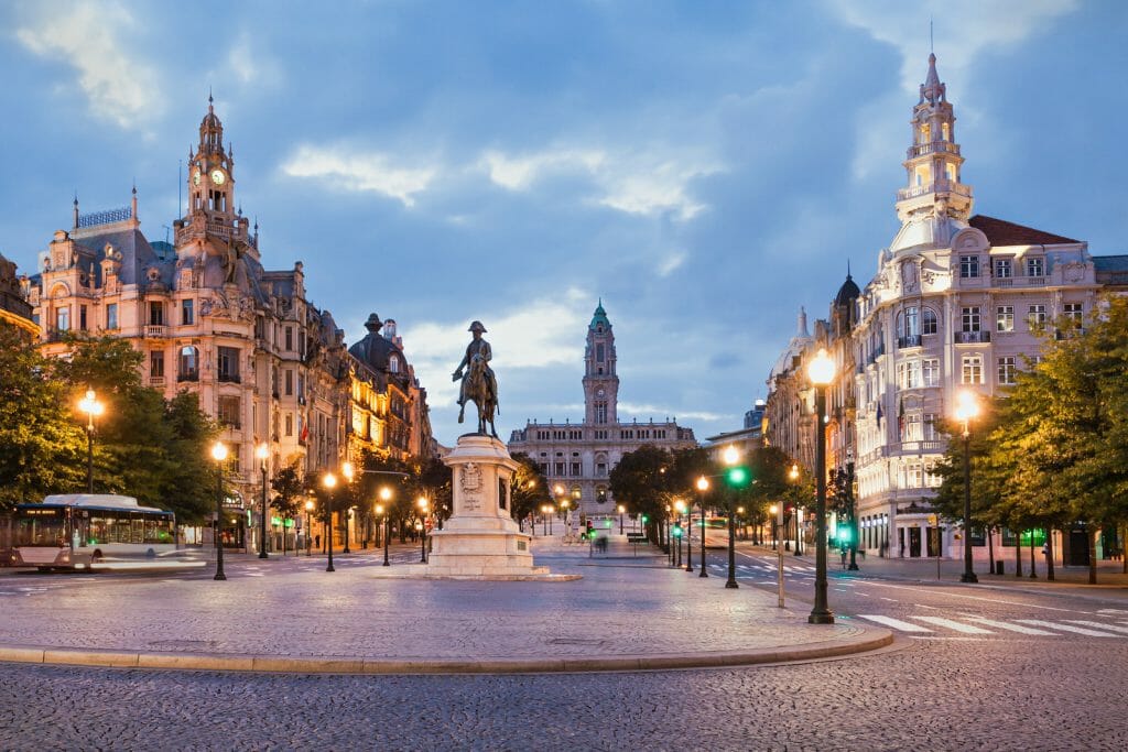 Liberdade Square in Porto with fountain and statues and historic buildings in the background in Porto Portugal
