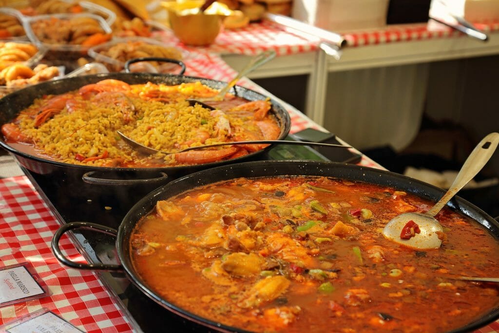 Street food stand with several pans of different Paellas in Barcelona Spain
