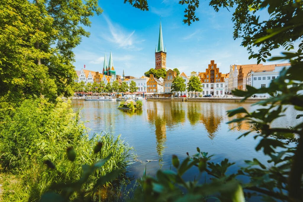 Classic panorama view of the historic city of Luebeck with famous Trave river in summer, Schleswig-Holstein, Most Romantic Cities in Northern Germany